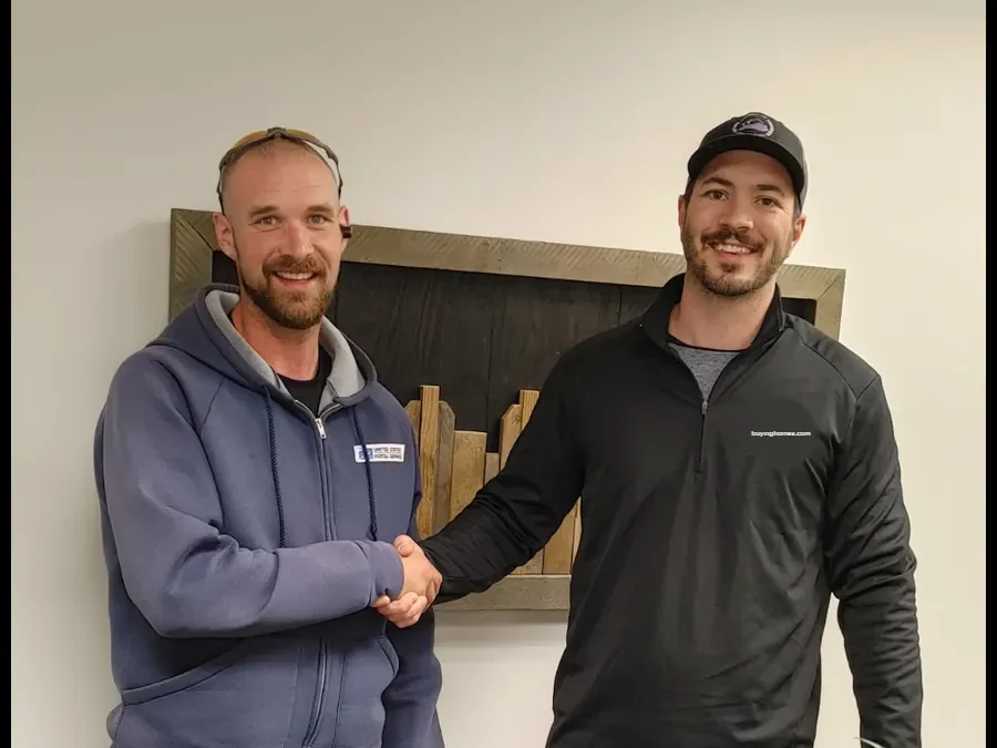 Dan shaking hands with a seller after closing